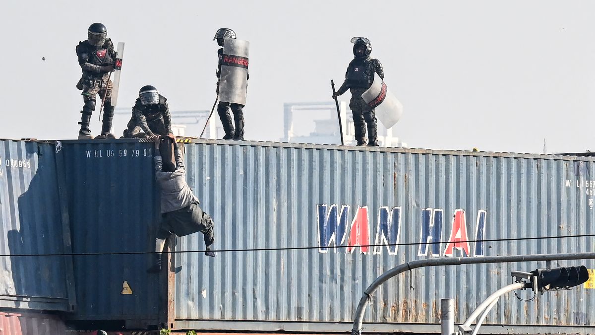 Paramilitary soldiers try to detain a supporter of the Pakistan Tehreek-e-Insaf (PTI) party on top of a shipping container during a protest demanding the release Imran Khan, at the Red Zone area in Islamabad. AFP Paramilitary soldiers try to detain a supporter of the Pakistan Tehreek-e-Insaf (PTI) party on top of a shipping container during a protest demanding the release Imran Khan, at the Red Zone area in Islamabad. AFP