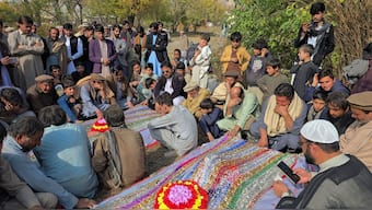 People mourn over the graves of relatives who were killed after gunmen opened fire on passenger vehicles in the Kurram tribal district of Khyber Pakhtunkhwa province, in Shalozan, Pakistan. Reuters