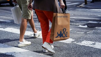 Shoppers cross Sixth Avenue in the Manhattan borough of New York City. Many in the US are turning to retail therapy to cope with Donald Trump’s landslide election win. Representational image/Reuters