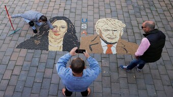 Kosovo artist Alkent Pozhegu works on a mosaic made of grains showing portraits of US Vice President Kamala Harris and former US President Donald Trump, in Gjakova, Kosovo. The close race between the two have got many asking about a possibility of a tie in the US polls. Reuters