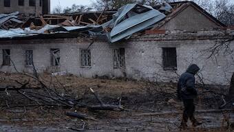 A resident walks at the site of a Russian missile strike, amid Russia's attack on Ukraine, in Dnipro, Ukraine. Reuters