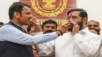 Maharashtra Chief Minister Eknath Shinde with Deputy Chief Minister Devendra Fadnavis celebrates the BJP-led Mahayuti alliance's win in the Maharashtra Assembly elections, at CM's official residence 'Varsha' in Mumbai. PTI