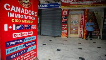 A girl stands outside an immigration consultant office at a market in Amritsar, in the northern state of Punjab, India, September 22, 2023. Reuters