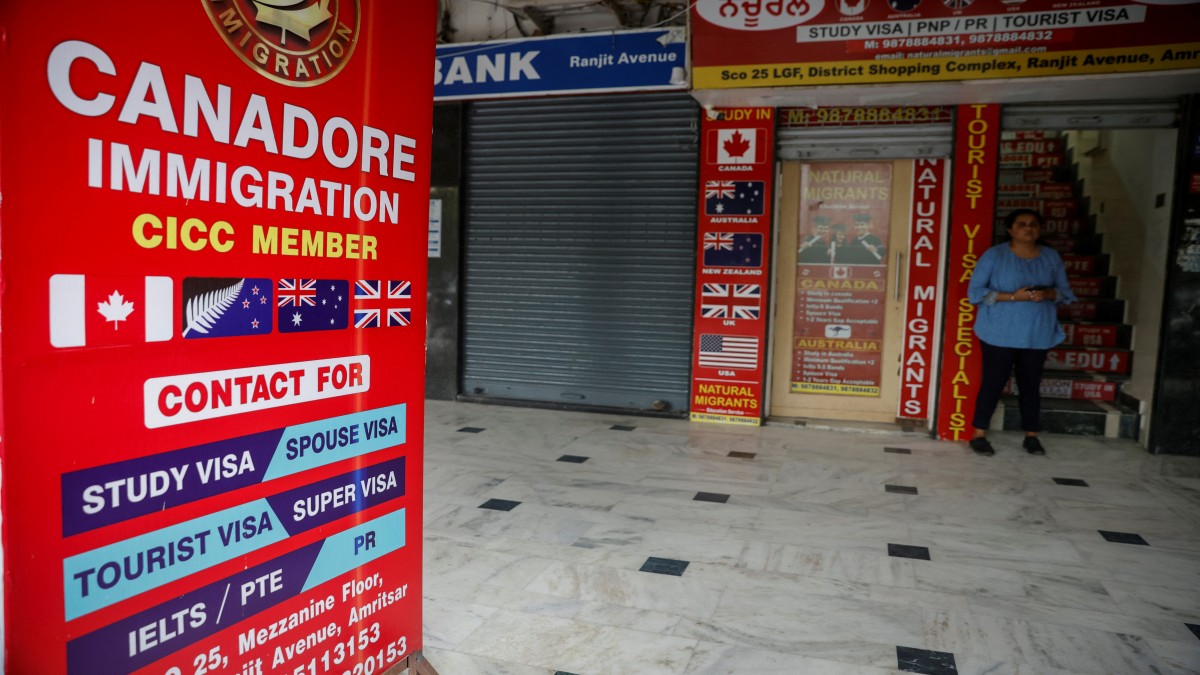 A girl stands outside an immigration consultant office at a market in Amritsar, in the northern state of Punjab, India, September 22, 2023. Reuters A girl stands outside an immigration consultant office at a market in Amritsar, in the northern state of Punjab, India, September 22, 2023. Reuters