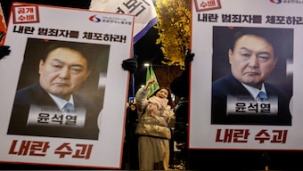Protesters hold placards during a candlelight vigil to condemn South Korean President Yoon Suk Yeol's surprise declarations of the failed martial law and to call for his resignation in Seoul, South Korea, December 5, 2024. Reuters