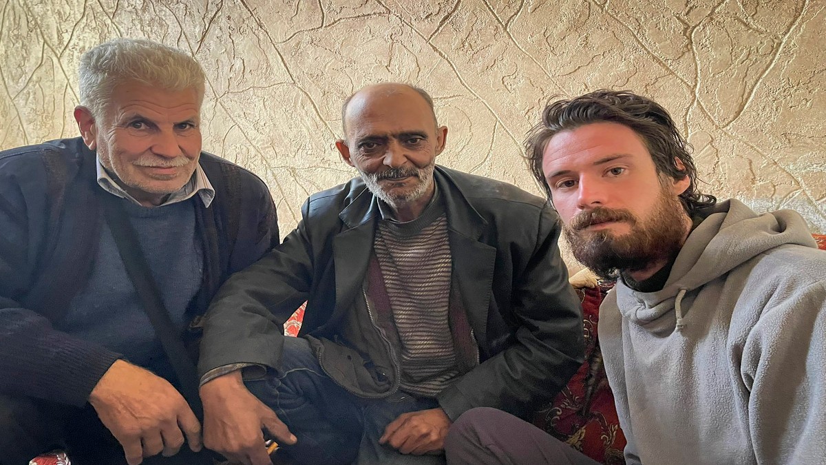 In this photo provided by the Syrian Emergency Task Force, American Travis Timmerman, right, sits with Mosaed al-Rifai, center, who found him in the Syrian desert, and the owner of the house where he took refuge, left, name not available, in Damascus, Syria on Thursday December 12, 2024. AP In this photo provided by the Syrian Emergency Task Force, American Travis Timmerman, right, sits with Mosaed al-Rifai, center, who found him in the Syrian desert, and the owner of the house where he took refuge, left, name not available, in Damascus, Syria on Thursday December 12, 2024. AP