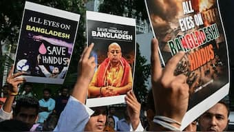 Devotees and members of Iskcon hold posters during a protest outside the Bangladesh High Commission in Mumbai on December 2, 2024, amid the unrest in Bangladesh after the arrest of Hindu monk Chinmoy Krishna Das Brahmachari. Source: AFP.