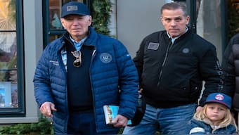 President Joe Biden accompanied by his son Hunter Biden and his grandson Beau leave a book store as they walk in downtown Nantucket Mass., on Friday. AP 