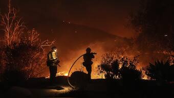 Firefighters battle the Franklin Fire in Malibu, Calif. AP