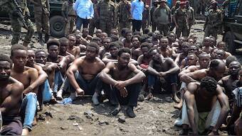 People arrested during a military operation to prevent a planned demonstration against the United Nations by a religious sect, sit on the ground and guarded by the army in Goma, eastern Democratic Republic of Congo. File image/ AFP