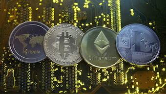 Representations of the Ripple, Bitcoin, Etherum and Litecoin virtual currencies are seen on a PC motherboard in this illustration picture. Source: REUTERS.