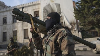 A Syrian opposition fighter holds a rocket-launcher. AP