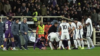 Fiorentina midfielder Edoardo Bove is surrounded by teammates as well as Inter Milan players and medical professionals after collapsing on the field during Sunday's Serie A meeting in Florence. AP