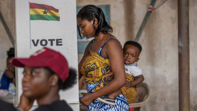 A woman with her child prepares her ballot in the general elections in Accra, Ghana. File image/AP