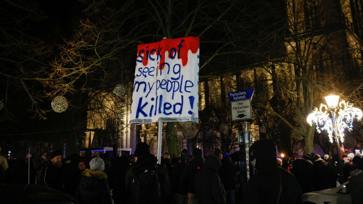 A person carries a placard as people gather on the day of a rally of Alice Weidel, co-leader of the far-right Alternative for Germany party (AfD). File Image/Reuters A person carries a placard as people gather on the day of a rally of Alice Weidel, co-leader of the far-right Alternative for Germany party (AfD). File Image/Reuters