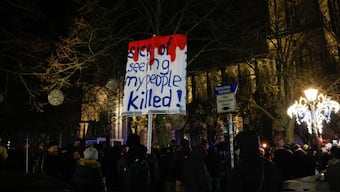 A person carries a placard as people gather on the day of a rally of Alice Weidel, co-leader of the far-right Alternative for Germany party (AfD). File Image/Reuters