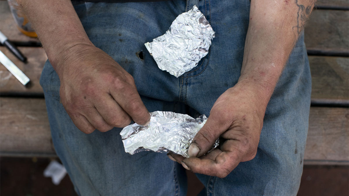 (File) A man prepares to smoke fentanyl on a park bench. AP (File) A man prepares to smoke fentanyl on a park bench. AP