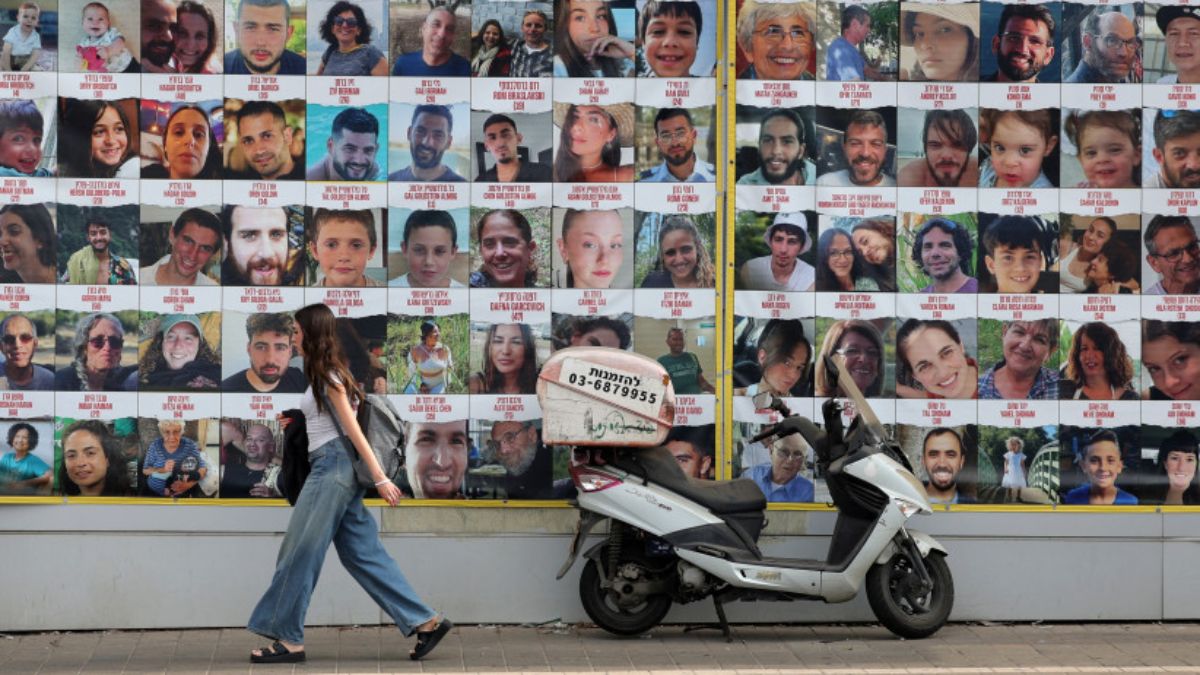 People walk past a wall displaying posters of hostages in Tel Aviv, Israel, August 18, 2024 (Photo: Reuters) People walk past a wall displaying posters of hostages in Tel Aviv, Israel, August 18, 2024 (Photo: Reuters)