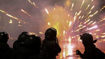 A law enforcement officer fires a tear gas canister as fireworks explode during a protest against the new government's decision to suspend the European Union accession talks and refuse budgetary grants until 2028, in Tbilisi, Georgia. Reuters