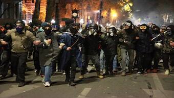 Demonstrators walk along a street during a rally to protest against the government's decision to suspend negotiations on joining the European Union in Tbilisi, Georgia, early Wednesday. AP 