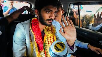 World chess champion D Gukesh poses with the trophy on his arrival from Singapore in Chennai. PTI 
