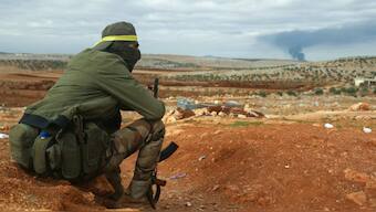 A fighter from Hayat Tahrir al-Sham (HTS) mans a position in the eastern outskirts of Atarib town, in Syria's Aleppo province. AFP