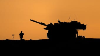 The silhouettes of a military vehicle and a soldier are seen near the Gaza border, amid the ongoing conflict in Gaza between Israel and Hamas, in Israel, on December 16, 2024. Reuters File
