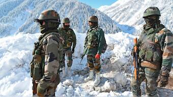 Indian soldiers stand on a snow-covered road near Zojila mountain pass that connects Srinagar to Ladakh, bordering China. Source: AFP | File.
