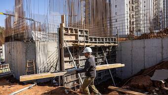 An Indian builder works on a construction site abroad. AFP