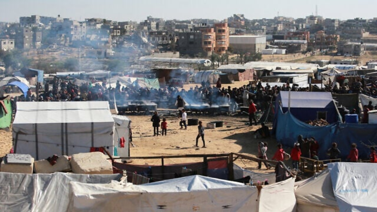 Palestinians stand in wait for a food portion at a distribution center south of Khan Younis in the southern Gaza Strip on Tuesday. AFP Palestinians stand in wait for a food portion at a distribution center south of Khan Younis in the southern Gaza Strip on Tuesday. AFP