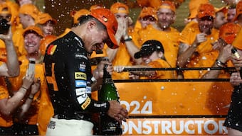 Lando Norris celebrates with the rest of the McLaren team after winning the season-ending Abu Dhabi Grand Prix at the Yas Marina Circuit. Reuters