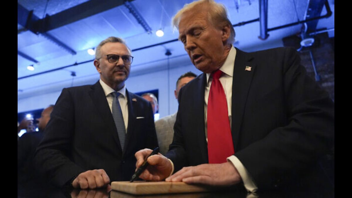 Donald Trump, right, signs autographs as Massad Boulos watches during a visit to Dearborn, Michigan on November 1, 2024. AP Donald Trump, right, signs autographs as Massad Boulos watches during a visit to Dearborn, Michigan on November 1, 2024. AP