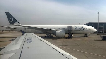 Pakistan International Airlines (PIA) passenger plane sits on tarmac, as seen through a plane window, at the Islamabad International Airport, Islamabad, Pakistan. Reuters