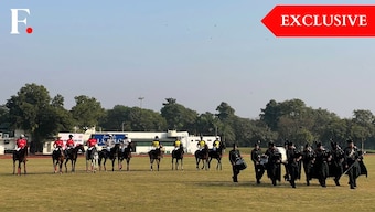 Polo players from the Mayfair Polo team and the Delta Polo team, as well as the umpires line up as the Army pipes and drums commence the final of the Col. Girdhari Memorial Polo Cup at the Jaipur Polo Ground in New Delhi, December 1, 2024. Firstpost/Anmol Singla