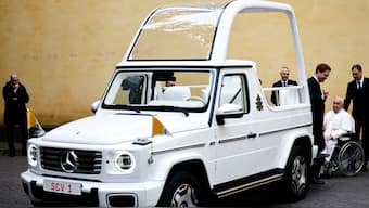 Pope Francis reacts as he receives a new open popemobile next to Mercedes-Benz Group CEO Ola Kallenius at the Vatican. Reuters