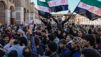  Demonstrators chant slogans and wave the new Syrian flag as they gather for Friday prayers at the Umayyad mosque in Damascus, Syria, Friday, Dec. 13, 2024. Image- Reuters
