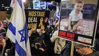 Demonstrators gather with signs during an anti-government protest calling for action to secure the release of Israeli hostages held captive since the October 7 attacks by Palestinian militants in the Gaza Strip, outside the Israeli Defence Ministry headquarters in Tel Aviv on December 21, 2024 AFP File