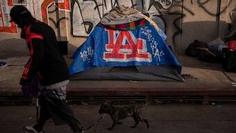  A man walks past a homeless encampment in downtown Los Angeles, Wednesday, Oct. 25, 2023.  Representative Image- AP