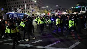 Police officers walk among the crowd, after South Korean President Yoon Suk Yeol declared martial law, in Seoul, South Korea, on Wednesday. Reuters