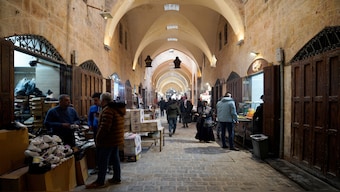 People walk at a souk, after Syrian rebels announced that they have ousted Bashar al-Assad, in Aleppo, Syria, on Monday. Reuters