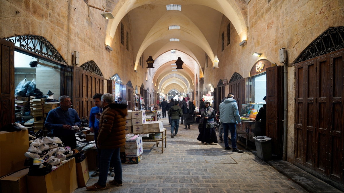 People walk at a souk, after Syrian rebels announced that they have ousted Bashar al-Assad, in Aleppo, Syria, on Monday. Reuters People walk at a souk, after Syrian rebels announced that they have ousted Bashar al-Assad, in Aleppo, Syria, on Monday. Reuters