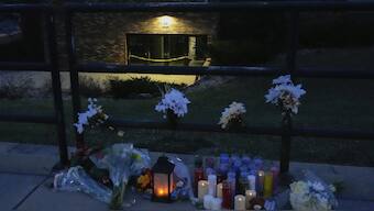 Flowers and candles are placed outside the Abundant Life Christian School Tuesday, Dec. 17, 2024 in Madison, Wis., following a shooting on Monday. AP