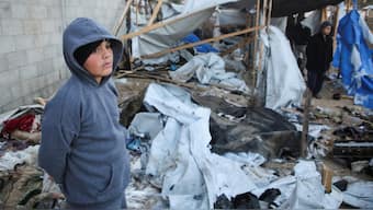 A Palestinian boy stands amidst the damage at a tent camp sheltering displaced people, following an Israeli strike, amid the Israel-Hamas conflict, in Al-Mawasi area, in Khan Younis, southern Gaza Strip. Reuters