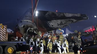 Rescue team carry the body of a passenger at the site of a plane fire at Muan International Airport in Muan, South Korea. AP