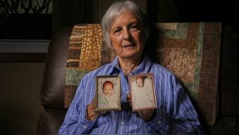 Peg Reif holds pictures of her children adopted from South Korea in the 1980s in her home Tuesday, Dec. 17, 2024 in Platteville, Wis. AP