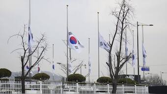 South Korean national flags fly at half-staff at a government complex in Seoul, South Korea, a day after a jetliner skidded off a runway, slammed into a concrete fence and burst into flames at an airport the town of Muan. AP
