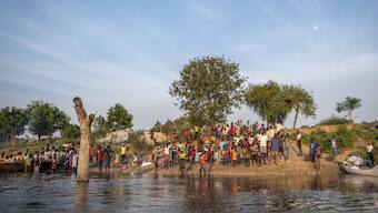 People gather along a flooded area in Jonglei state, South Sudan. AP