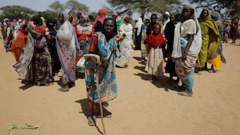 Sudanese refugees, who fled the violence in their country, wait to receive food supplies. File image/Reuters