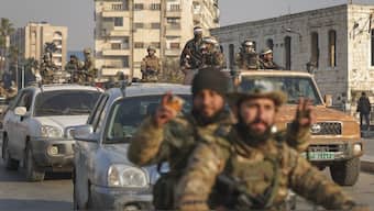 Syrian opposition fighters ride along the streets in the aftermath of the opposition's takeover of Hama, Syria. AP