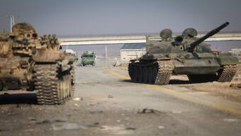 Abandoned Syrian army armoured vehicles sit on a road as opposition insurgents control the outskirts of Hama, Syria, on Tuesday. AP 